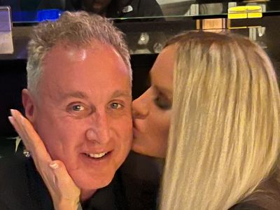 Nicole Dahm is kissing Michael Kelly on his cheek.